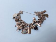 A silver bracelet and various charms