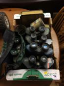 A quantity of binoculars etc.