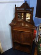 An Edwardian mirror back corner cabinet