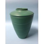 A Wedgwood Keith Murray cylindrical tapering vase on a dark green ground, 29cm height