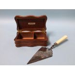 A silver plated presentation trowel, dated 1882 and a teakwood box from H. M. S. Nelson