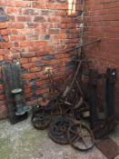 A large quantity of various sized cast iron wagon pulley wheels