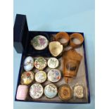 A collection of enamel pill boxes, Mauchline Wares and Doulton etc.