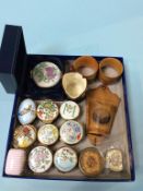 A collection of enamel pill boxes, Mauchline Wares and Doulton etc.