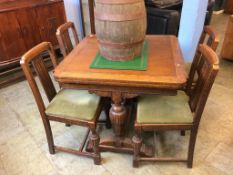 An oak drawer leaf table and four chairs