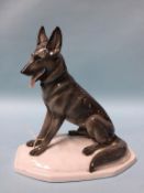 A Continental porcelain figure of an Alsatian dog