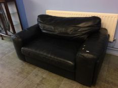 A black leather two seater settee