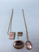 A Victorian agate set oval brooch, a Birmingham silver vesta case with silver chain, a Victorian