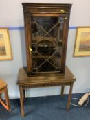 A mahogany fold over tea table and a mahogany hanging corner cabinet