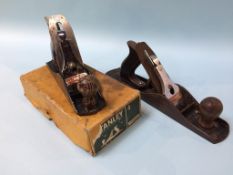 A Stanley wood plane, number 5 and a boxed Stanley plane, number 4