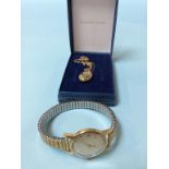 A ladies Omega wrist watch with numeral and batons, and a 9ct gold locket and chain, weight 1.5g
