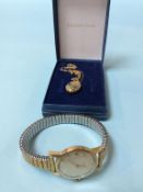 A ladies Omega wrist watch with numeral and batons, and a 9ct gold locket and chain, weight 1.5g