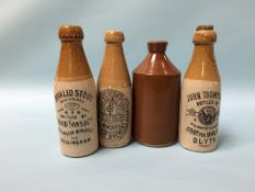 Three stoneware advertising bottles and one other (4)