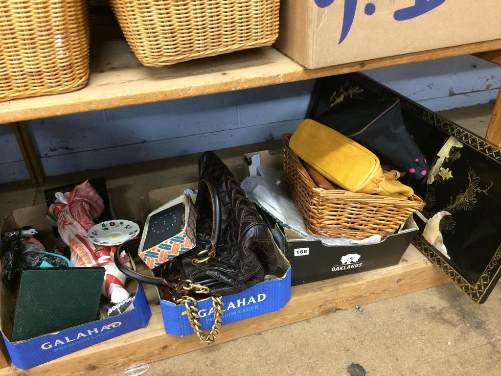 A shelf of assorted handbags, dolls etc.
