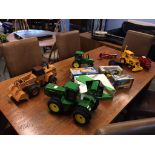 A large John Deer tractor, a Grain drill, a small John Deer tractor, a case digger, John Deer JCB