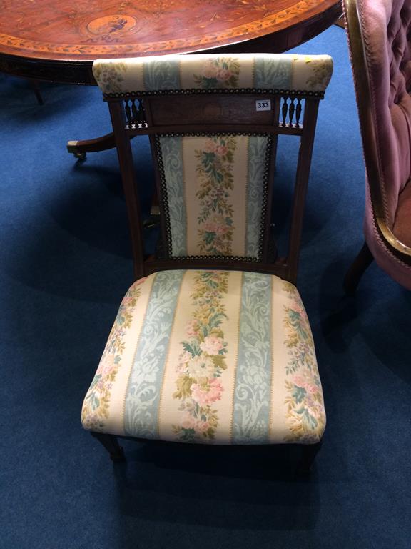An Edwardian and marquetry nursing chair