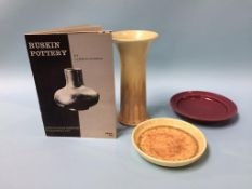 A Ruskin pottery spill vase, two dishes and a book 'Ruskin Pottery' by James H. Rushton