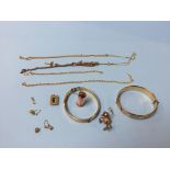 Two gold plated bangles and charms, and yellow metal necklaces etc.