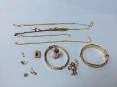 Two gold plated bangles and charms, and yellow metal necklaces etc.