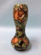 A Moorcroft vase with waisted body, decorated with squirrels, 28cm height