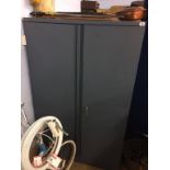 A grey metal two door cupboard