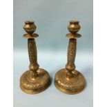 A heavy pair of decorative brass candlesticks. 31cm height