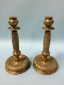 A heavy pair of decorative brass candlesticks. 31cm height