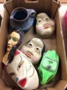 A selection of masks, car teapot and Denby ware jug