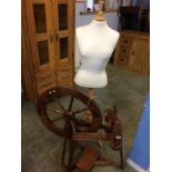 A spinning wheel and tailors dummy