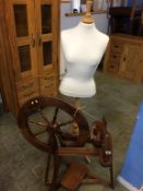 A spinning wheel and tailors dummy