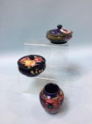 Two Moorcroft circular lidded bowls and a small vase