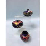 Two Moorcroft circular lidded bowls and a small vase