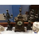 A late 19th century clock with 8 day movement, strike action and a pair of candelabra, 50cm height