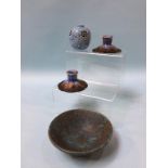 A Ruskin pottery shallow bowl, a small Ruskin pierced blue vase and a pair of candlesticks