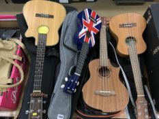 Four ukuleles in soft cases