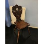 A carved oak hall chair