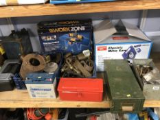 A quantity of assorted on one shelf, to include brass cannons and a router table etc.