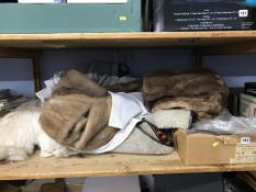 A shelf of fur coats