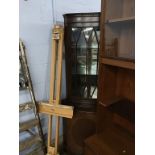 A reproduction mahogany corner cabinet