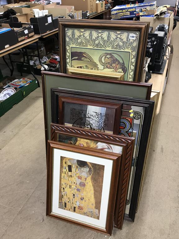 A collection of assorted framed prints and mirrors