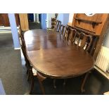 A mahogany extending dining table and eight chairs (2 + 6)
