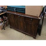 A reproduction mahogany sideboard and an oak dining table