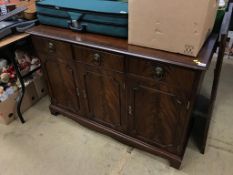 A reproduction mahogany sideboard and an oak dining table