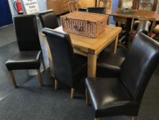 An oak Furniture Land extending table and six chairs