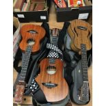 Three Aklot ukuleles, in soft cases