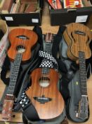 Three Aklot ukuleles, in soft cases