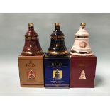 Three boxed commemorative bottles of Bells Whiskey
