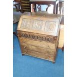 An oak linenfold bureau, 76cm width