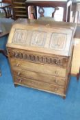 An oak linenfold bureau, 76cm width