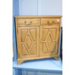 A small pine two drawer and two door side cabinet